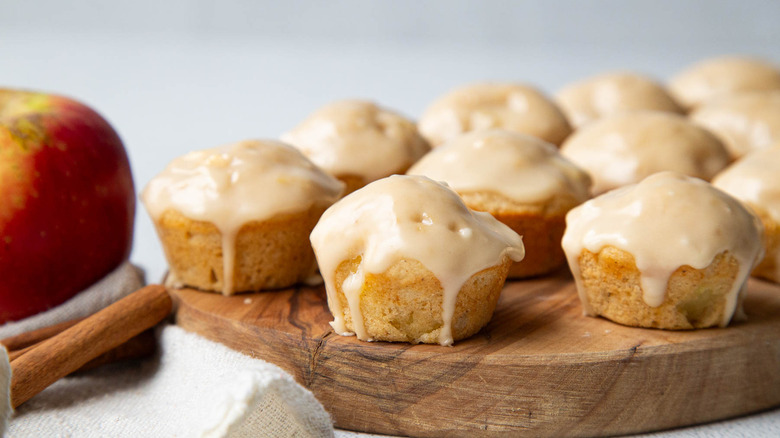 Glazed apple fritters on wooden board