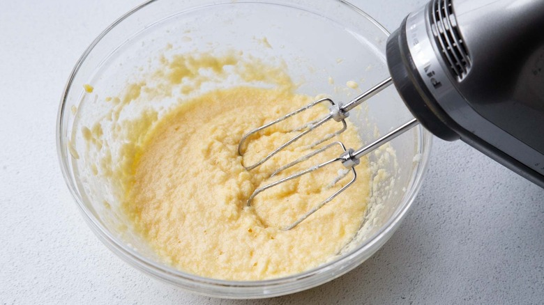 Fritter batter mixed in bowl with hand mixer