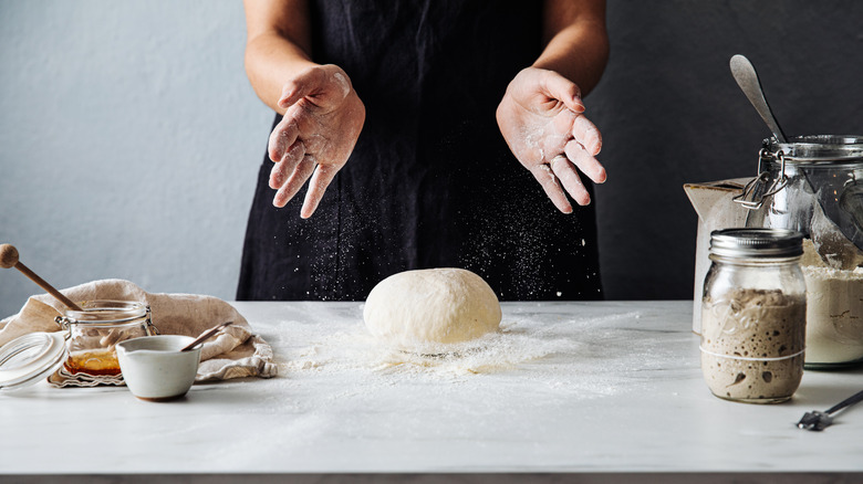 person making dough on counter