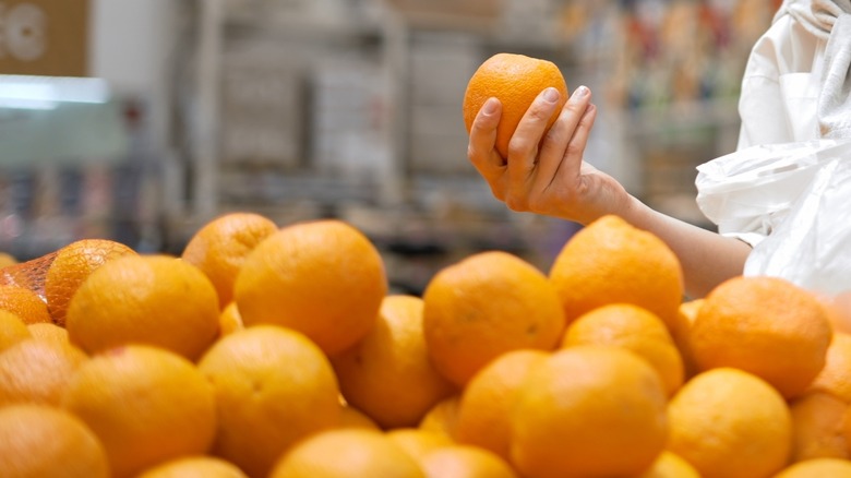 woman holding an orange