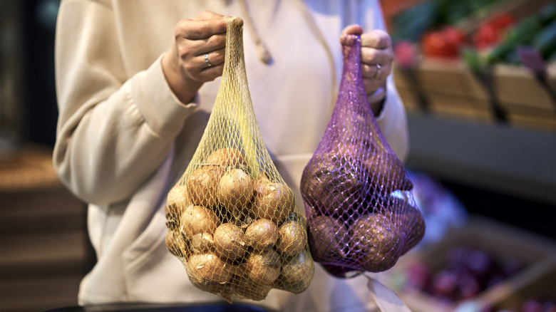 holding onions in bags