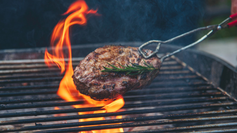 Person flipping a steak