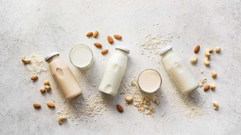 Various bottles and cups of nut milk 