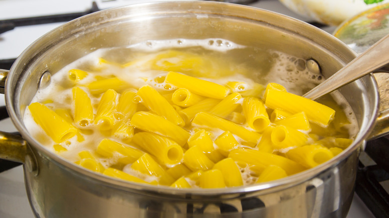 Rigatoni noodles boiling on stovetop