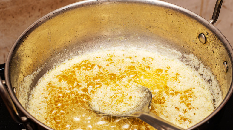 Butter heating in a pot to make clarified butter.