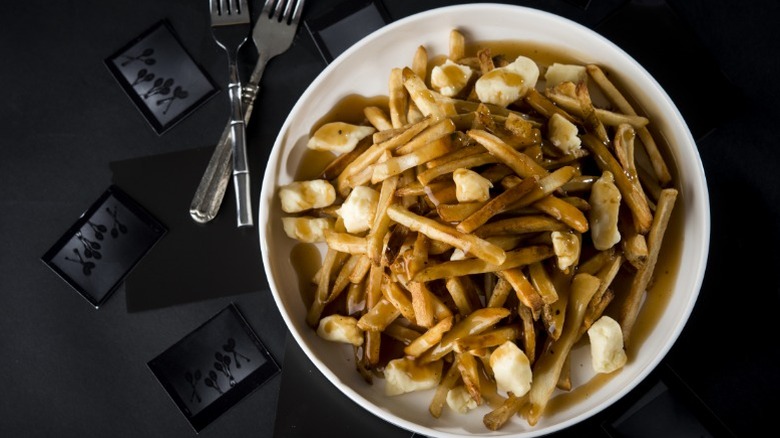 poutine in a white bowl