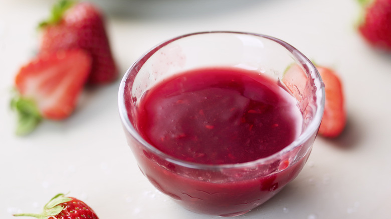 A bowl of strawberry syrup