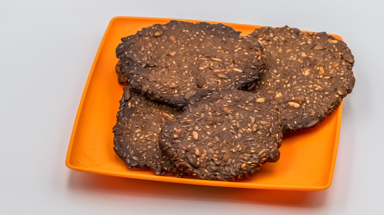 cookies made with flax seeds, sunflower seeds, and pumpkin on a rectangular orange plate