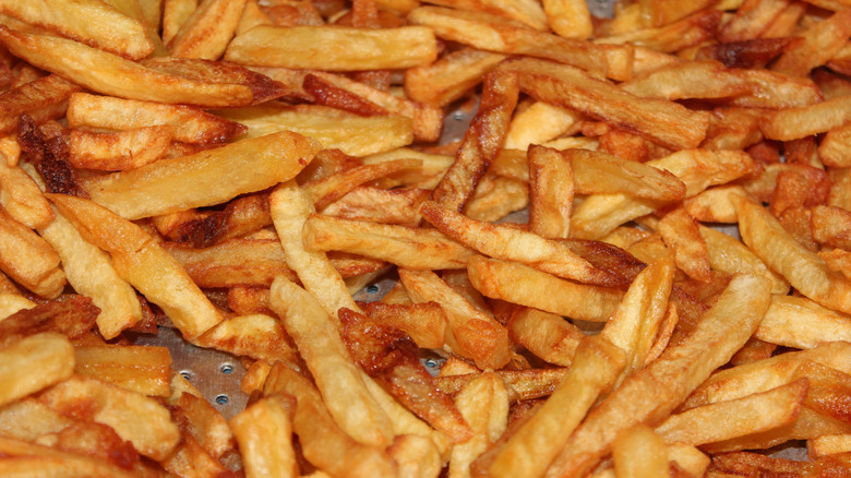 A close up photo of a large amount of french fries