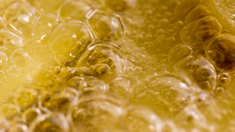 A close-up photo of cooking oil boiling