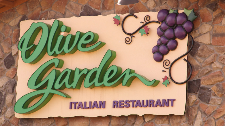 facade of Olive Garden restaurant featuring a sign with logo