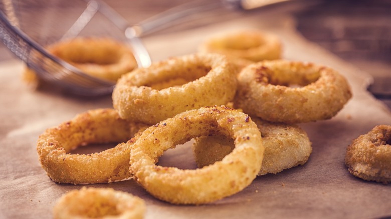 Onion rings arranged on a surface.