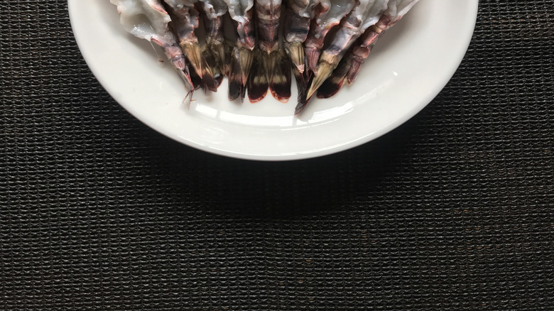 peeled and deveined shrimp, tails on, curve side up in a bowl