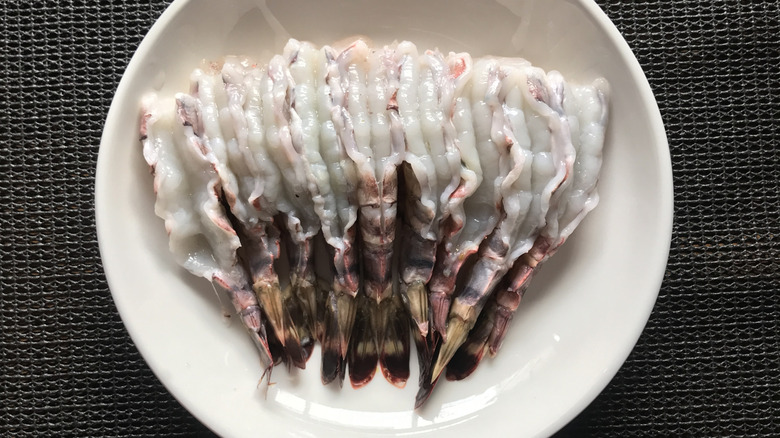 peeled and deveined shrimp, tails on, curve side up in a bowl