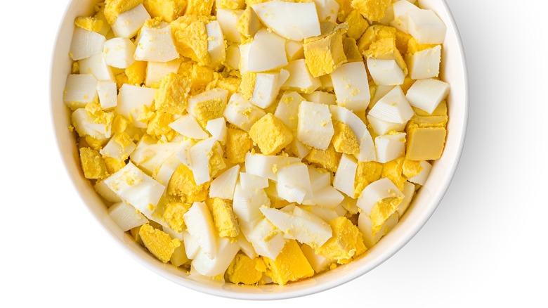 A bowl of diced hard boiled eggs.