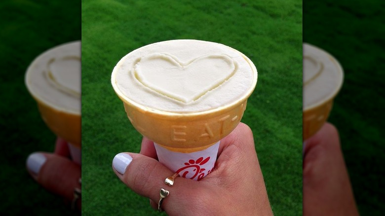 Hand holding Chick-fil-A Icedream Cone with a heart drawn in the top