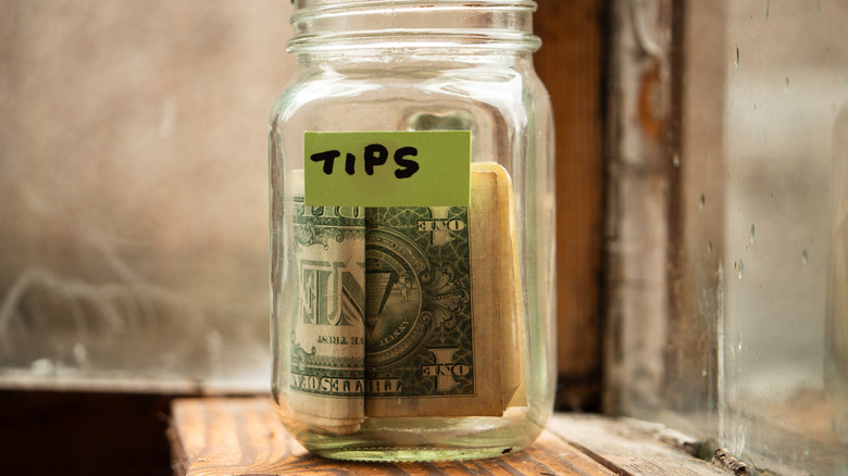 Tip jar on wooden ledge