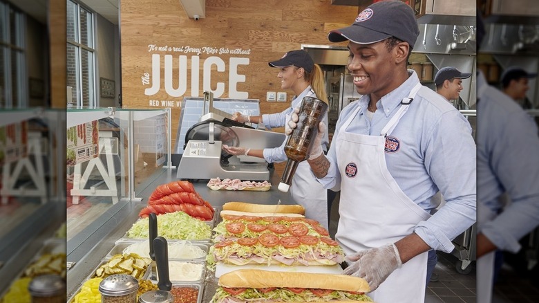 Employees making sub on assembly line