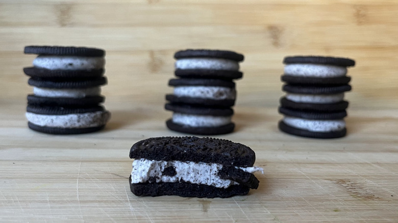 A closeup shows a Loaded Oreo with stacks of other Oreos in the background.