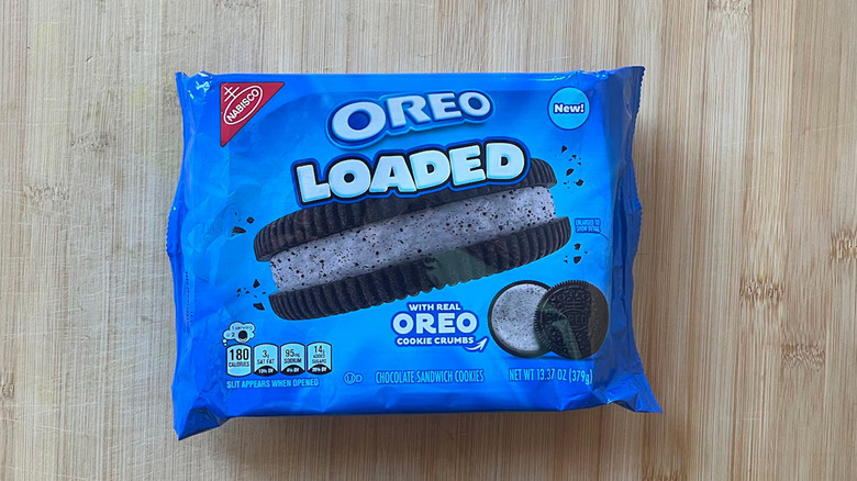 A pack of the new Loaded Oreo cookies sits on a table.