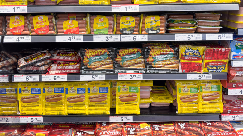 Different brands of wieners on shelves in a grocery store