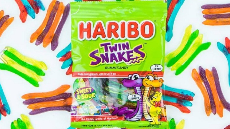 A package of Haribo Twin Snakes against a backdrop of the gummy snakes