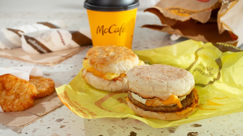 McDonald's breakfast sandwiches on their wrapping paper next to a McCafe