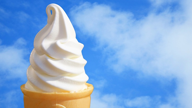 A vanilla soft serve ice cream cone.