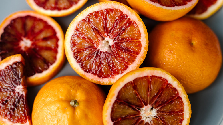 Halved and whole blood oranges