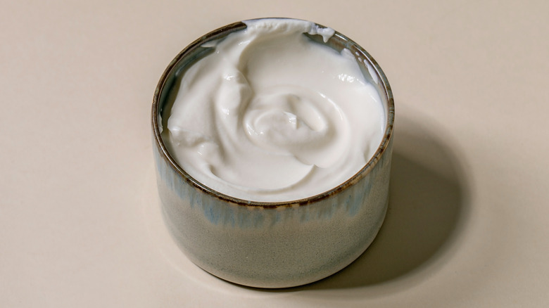 a ceramic bowl with sour cream in it