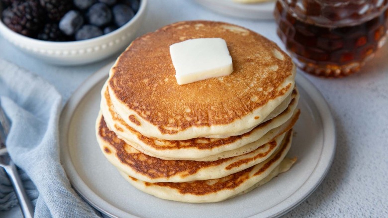 Stack of pancakes with butter pat on top