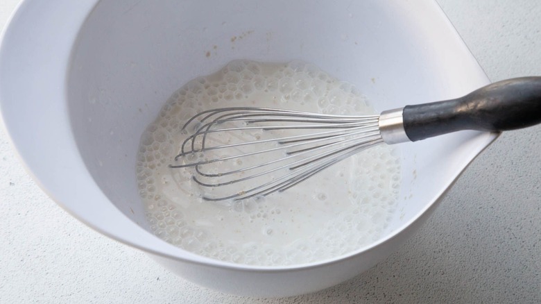 Milk and whisk in bowl