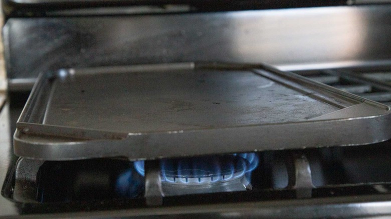 Griddle sitting over flame on stovetop