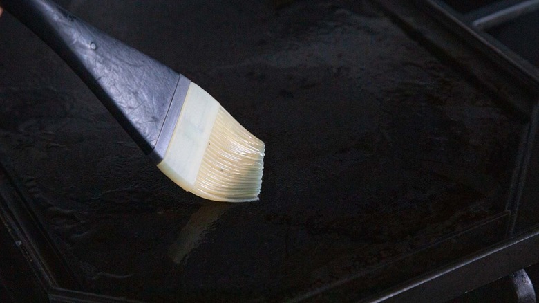 Pastry brush running over griddle