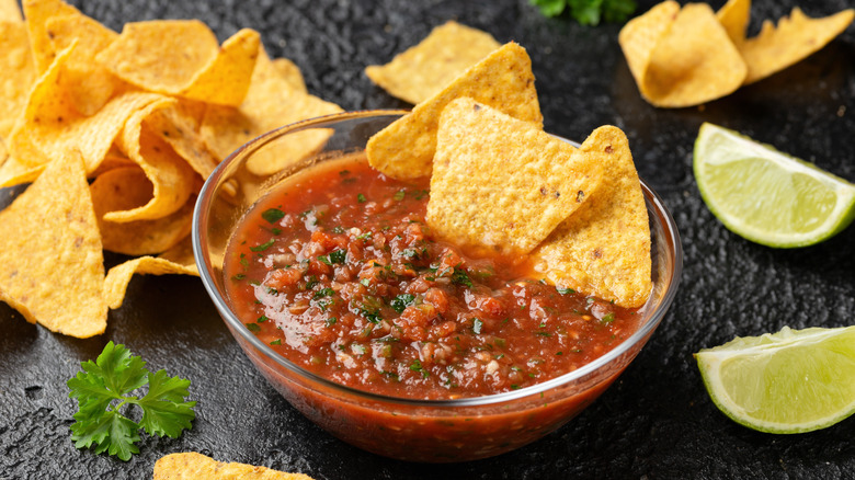 Salsa bowl and tortilla chips on table