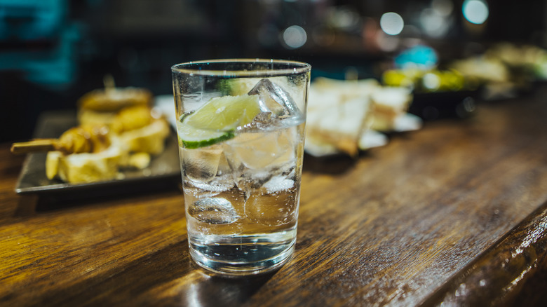 Gin and tonic sitting on bar counter