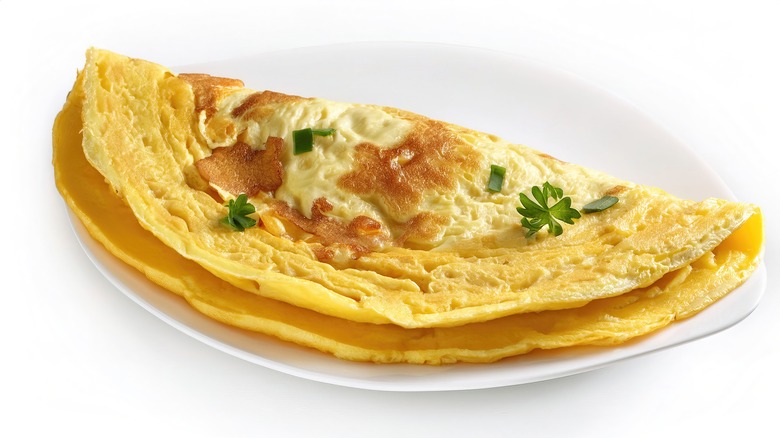 Simple omelet on white plate