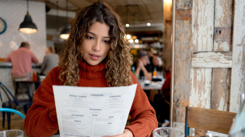 Restaurant patron reviewing menu