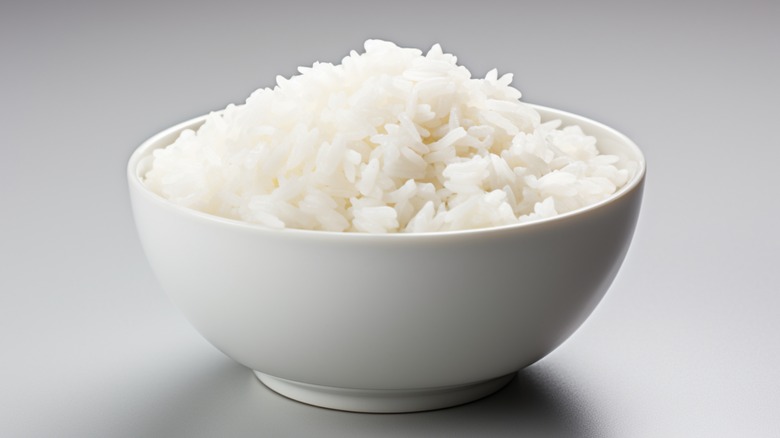 Plain rice in white bowl with gray background