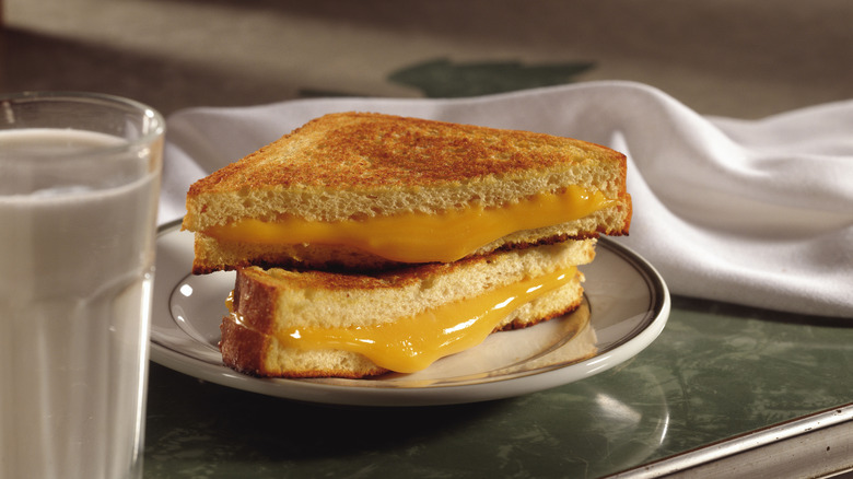 Simple grilled cheese on plate by water