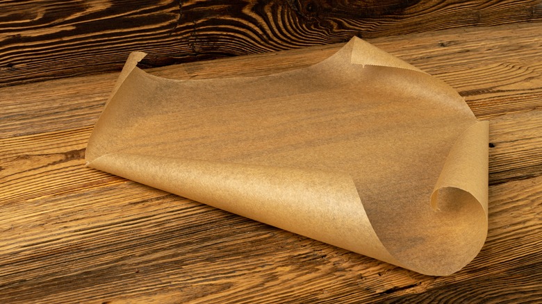 A sheet of parchment paper on a wooden table