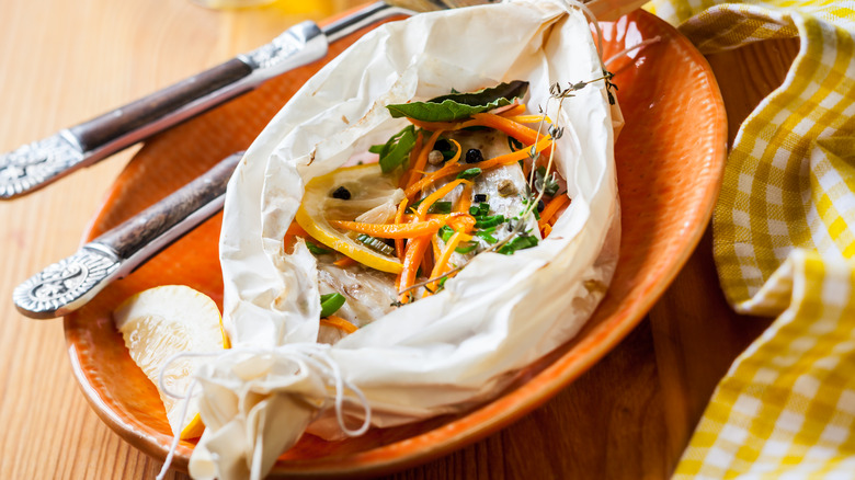 Fish cooked en papillote in a paper bundle