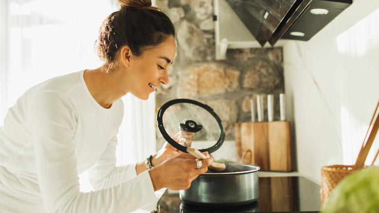 Person boiling pasta on stove