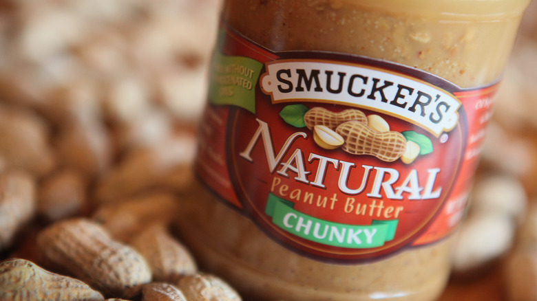 Jar of Smucker's chunky peanut butter with peanuts