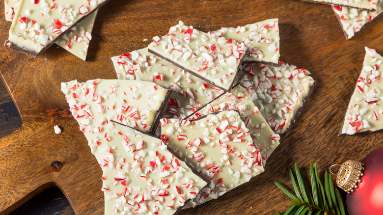 Pieces of peppermint bark on a wood serving tray