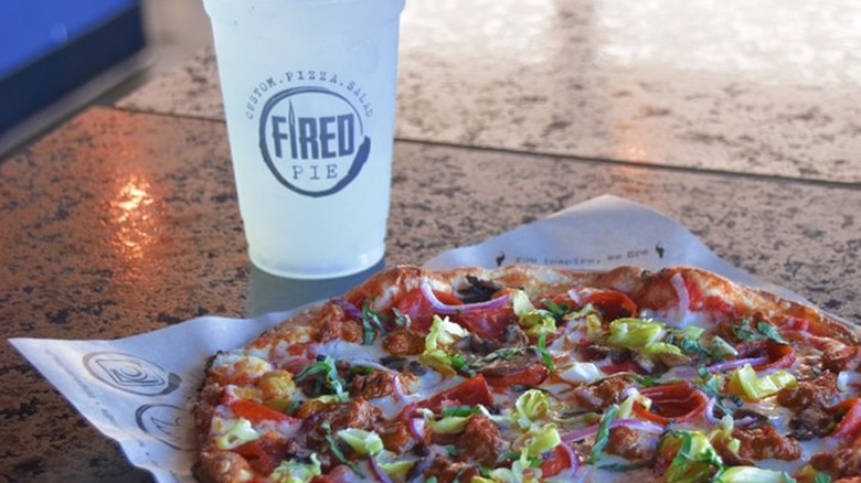 Pizza and a lemonade on a tabletop