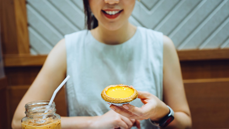 A woman trying out a Chinese egg tart