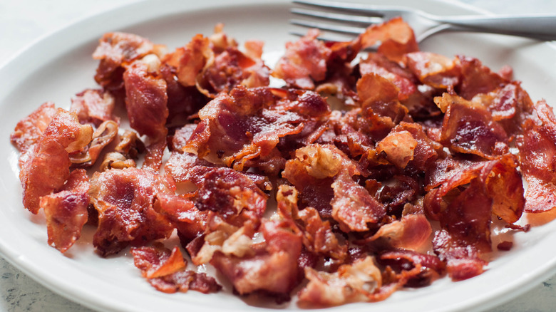 Crispy fried bacon pieces on a plate