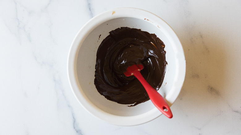 Chocolate in white bowl with red spatula