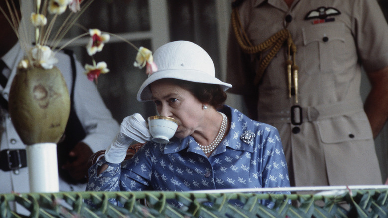 Queen Elizabeth II drinking tea